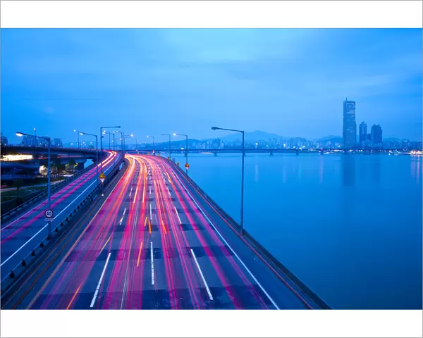 Korea, Seoul, Traffic on Expressway & Hanang River and 63 building on the right