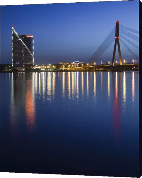 Latvia, Riga, Vansu Bridge, Swedbank building, and Daugava River, evening