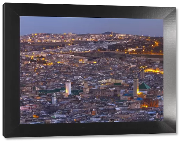 Elevated view across the Old Medina of Fes illuminated at Dusk, Fes, Morocco