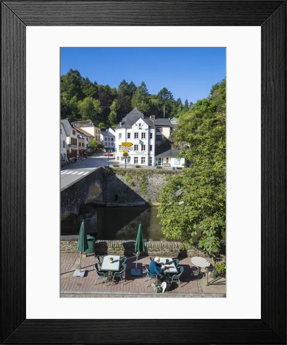 Framed Print : Luxembourg, Vianden, Man sitting at riverside cafe Framed Print : Luxembourg, Vianden, Man sitting at riverside cafe