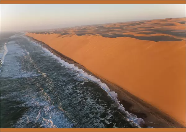Aerial view over sand dunes & sea, Namib Desert, Namibia