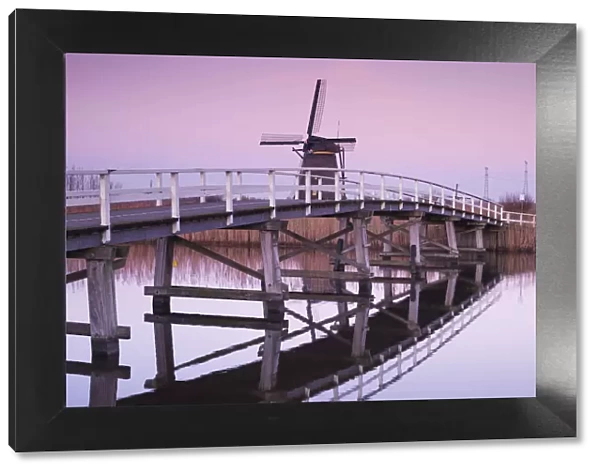 Netherlands, Kinderdijk, Traditional Dutch windmills and bridge, dusk