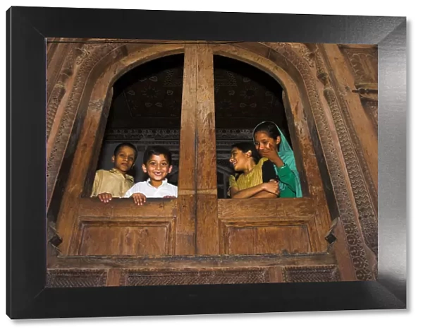 Pakistan, North West Frontier Province, Peshawar, Children looking out of windows