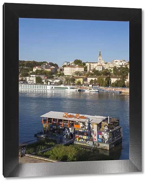 Serbia, Belgrade, View of floating bar and nightclub on Sava River across to St