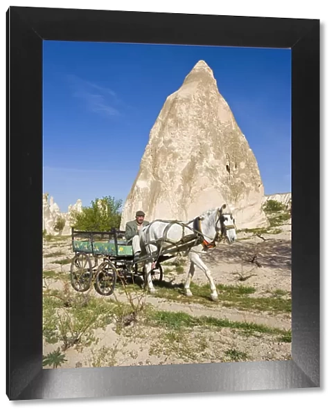 Man using traditional transport, Tufa rock formations, Rose Valley, nr Goreme, Cappadocia