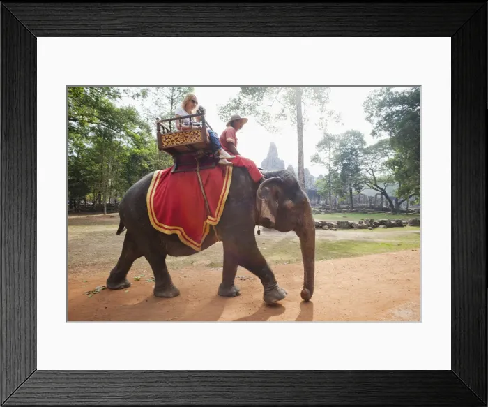 Framed Print : Cambodia, Siem Reap, Angkor Thom, Bayon Temple, Tourists on Elephant Framed Print : Cambodia, Siem Reap, Angkor Thom, Bayon Temple, Tourists on Elephant