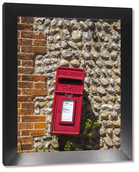 UK, England, Norfolk, North Norfolk, Blakeney, Red Post Box against traditional flint
