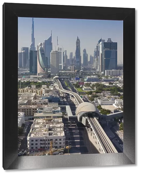 UAE, Dubai, Downtown Dubai skyline above metro rail