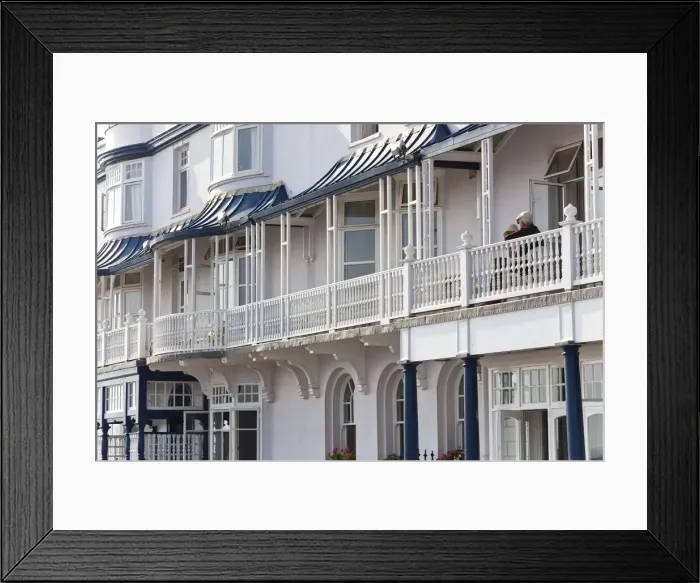 Framed Print : Retired couple sat on balcony, Regency houses, Sidmouth, Devon, UK Framed Print : Retired couple sat on balcony, Regency houses, Sidmouth, Devon, UK