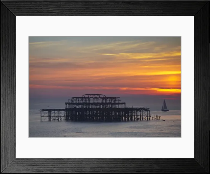 Framed Print : UK, England, Sussex, Brighton, Boat sailing past burn out remains of Brighton west Framed Print : UK, England, Sussex, Brighton, Boat sailing past burn out remains of Brighton west