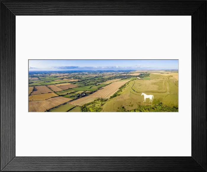 Framed Print : Aerial view of the famous White Horse below Bratton Camp, an Iron Age hillfort near