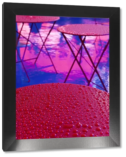 Abstract water droplets on a red table under the Neon lights of 42nd Street, Times Square