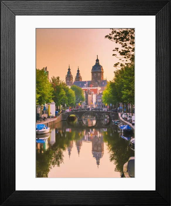 Framed Print : Church of St Nicholas reflecting in the canal at sunrise on a summer evening in Amsterdam Framed Print : Church of St Nicholas reflecting in the canal at sunrise on a summer evening in Amsterdam