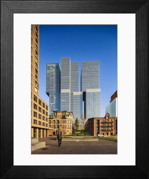 Framed Print : A man walking in Noordereiland island in Rotterdam at sunrise with skyscrapers in Framed Print : A man walking in Noordereiland island in Rotterdam at sunrise with skyscrapers in