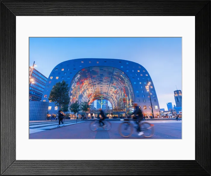 Framed Print : People riding bikes in front of the Market Hall in Rotterdam on a summer evening Framed Print : People riding bikes in front of the Market Hall in Rotterdam on a summer evening