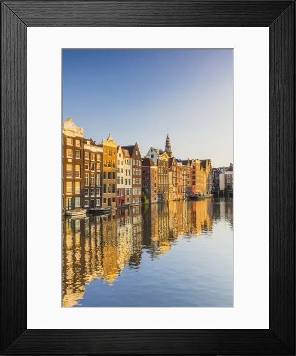 Framed Print : Typical houses reflecting in Damrak water canal at sunset in Amsterdam