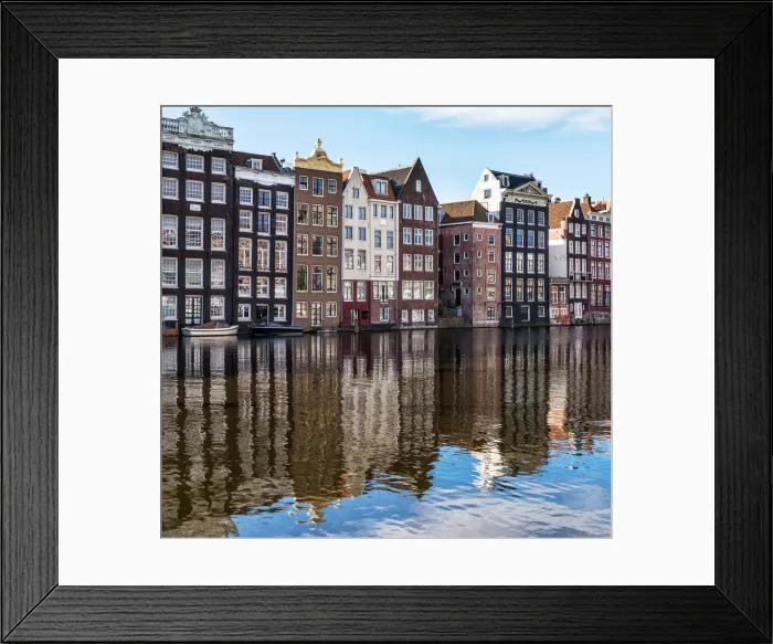 Framed Print : Traditional buildings along the Damrak reflected in the canal, Amsterdam, the Netherlands Framed Print : Traditional buildings along the Damrak reflected in the canal, Amsterdam, the Netherlands