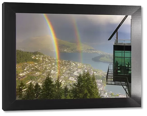 View of Queenstown and Wakatipu lake with a double rainbow at sunset, Otago, South Island