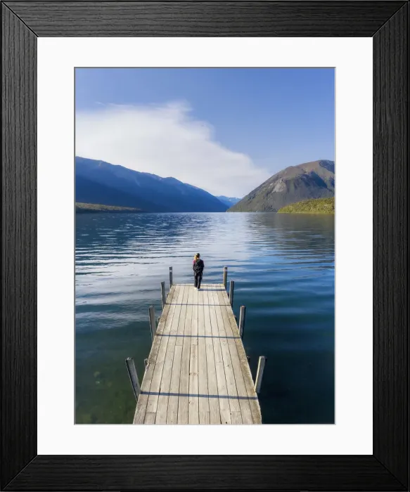 Framed Print : A woman standing on the wooden jetty and enjoying the view of the Rotoiti lake Framed Print : A woman standing on the wooden jetty and enjoying the view of the Rotoiti lake