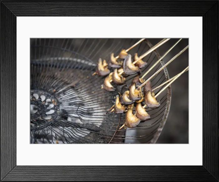 Framed Print : Africa, SA£o Toma and Principe. Grilled snails on a skewer in a little shop on the road