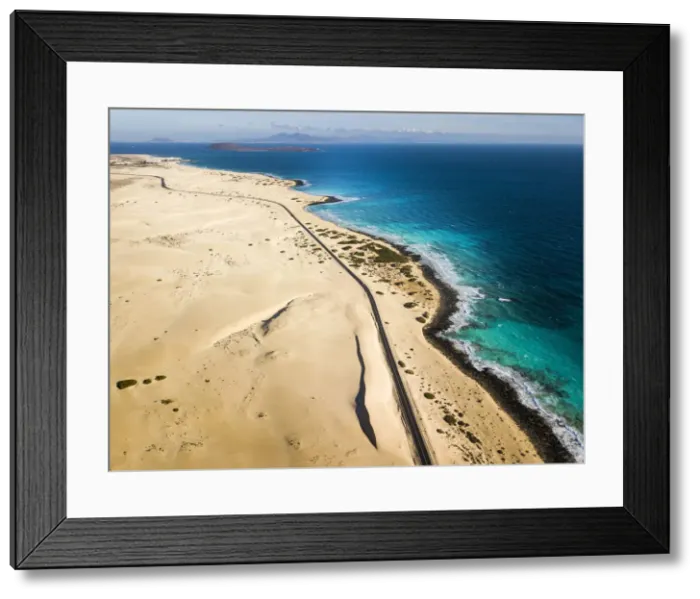 Framed Print : Scenic route in Fuerteventura, Corralejo sand dunes and ocean. Canary islands Framed Print : Scenic route in Fuerteventura, Corralejo sand dunes and ocean. Canary islands