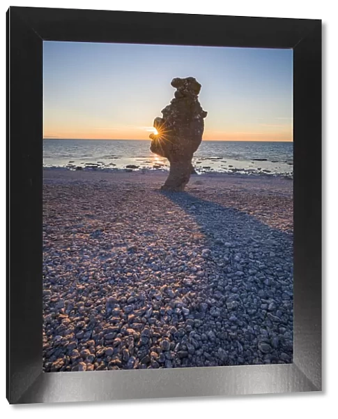Sweden, Faro Island, Langhammars Area, Langhammar coastal limestone raukar rock, sunset
