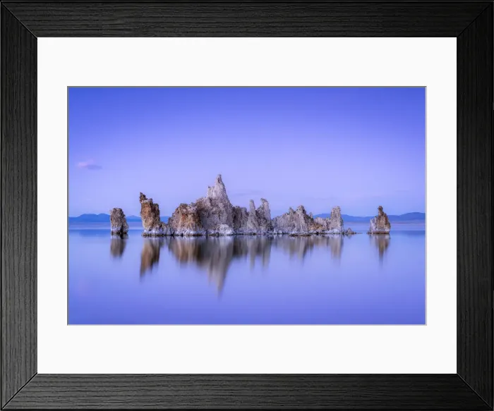 Framed Print : Reflection of rock formation in South Tufa on Mono Lake against blue sky at dusk Framed Print : Reflection of rock formation in South Tufa on Mono Lake against blue sky at dusk