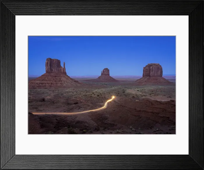 Framed Print : Light trail from car driving on scenic drive road near The Mitten Buttes in Monument Framed Print : Light trail from car driving on scenic drive road near The Mitten Buttes in Monument
