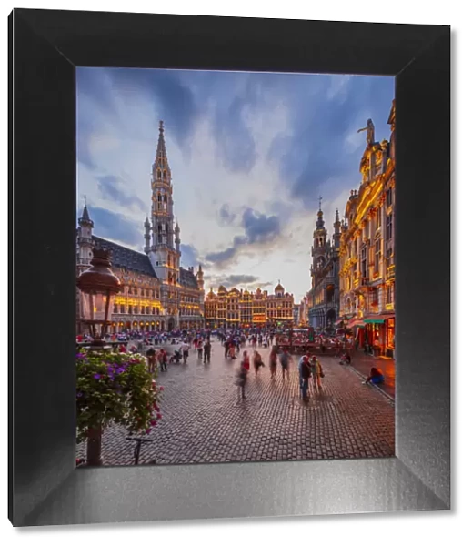 People walking in the Grand Place in Brussels with the Town Hall in the background at
