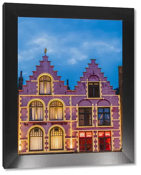 Details of the typical colored houses facades in Markt square in Bruges by night, Belgium