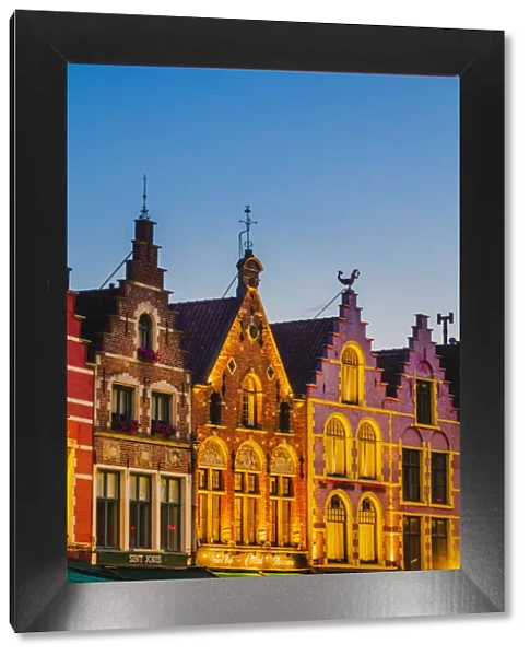 Detail of the colored houses facades in Markt Square in Bruges by night, Belgium