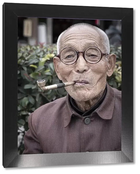 Asia, China, Shaanxi Province, Xian, local man smoking a traditional pipe