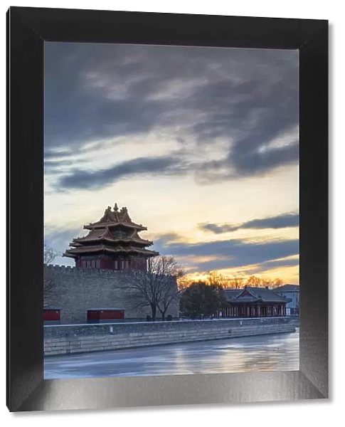 Tower and moat of Forbidden City at sunset, Beijing, China