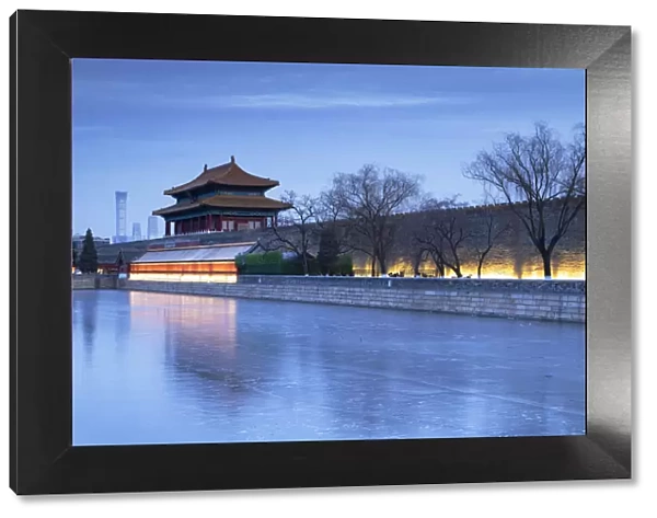 North Gate and moat of Forbidden City at dusk with CITIC Tower in background, Beijing