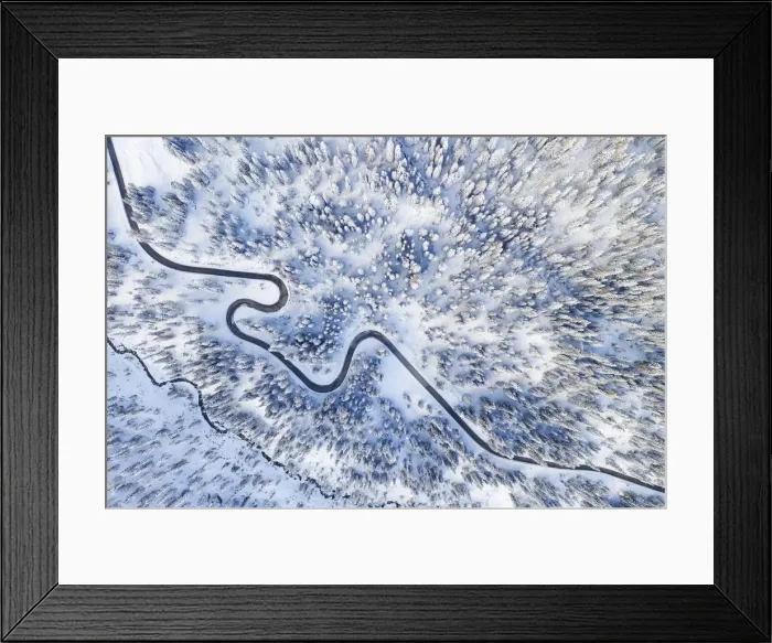 Framed Print : the black snake that leads to Giau Pass, surrounded by trees and snow-covered meadows