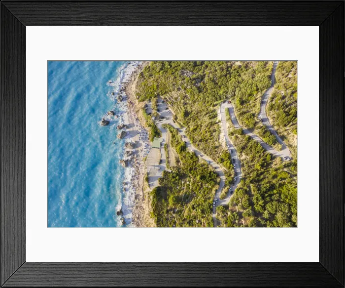 Framed Print : Aerial view of the winding road to Megali Petra beach. Lefkada, Ionian Islands region Framed Print : Aerial view of the winding road to Megali Petra beach. Lefkada, Ionian Islands region