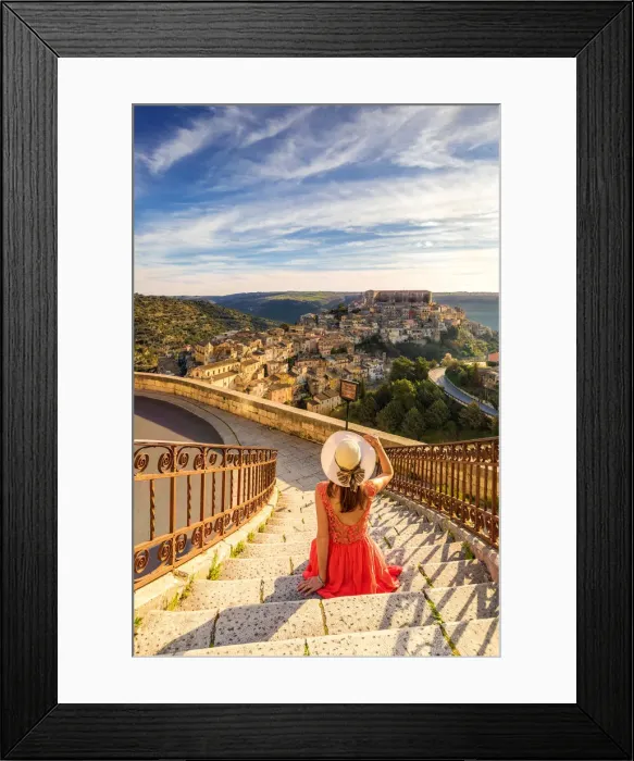 Framed Print : Young woman admiring the enchanting hilltop city of Ragusa Ibla from the stairs of Santa Framed Print : Young woman admiring the enchanting hilltop city of Ragusa Ibla from the stairs of Santa