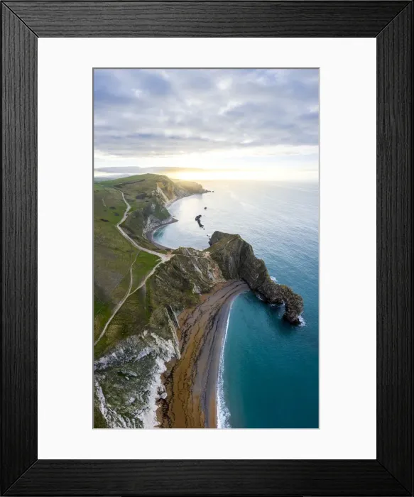 Framed Print : Aerial view at sunrise of the Durdle Door, a natural limestone arch on the Jurassic Coast Framed Print : Aerial view at sunrise of the Durdle Door, a natural limestone arch on the Jurassic Coast