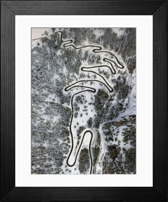 Framed Print : Aerial view of curves of the Maloja pass after a snowfall, Maloja Pass, Bregaglia Valley