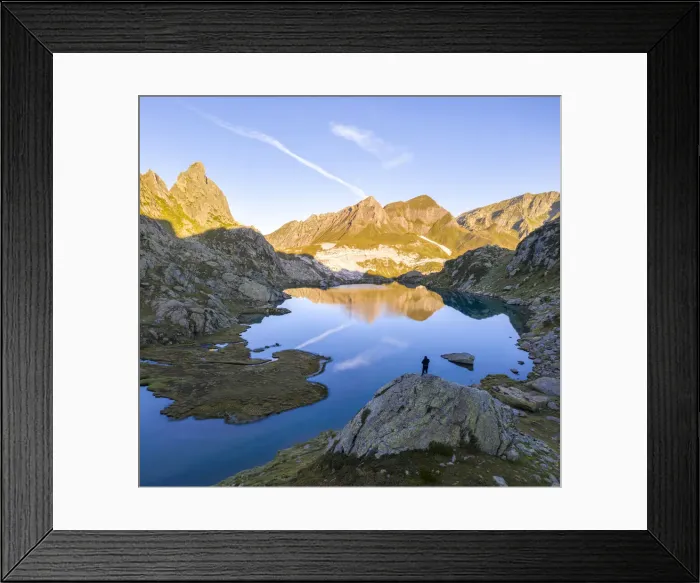 Framed Print : A lonely man admiring a sunrise at Lago Leit with Pizzo Prevat reflecting on it Framed Print : A lonely man admiring a sunrise at Lago Leit with Pizzo Prevat reflecting on it