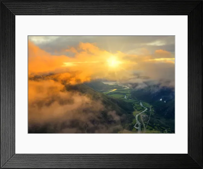 Framed Print : Aerial view of sun rays in the sunset sky lighting up the clouds over Romsdalen valley Framed Print : Aerial view of sun rays in the sunset sky lighting up the clouds over Romsdalen valley