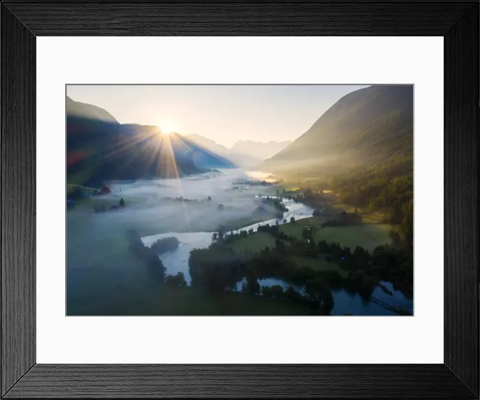 Framed Print : Sunburst during a foggy sunrise over Stryneelva river and fields, aerial view, Stryn