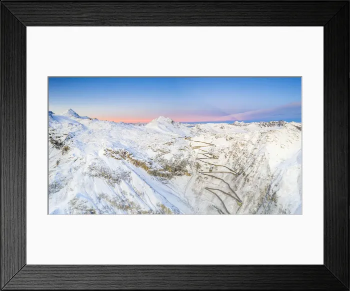 Framed Print : Aerial panoramic of Stelvio Pass and winding road covered with snow at dawn, Bormio Framed Print : Aerial panoramic of Stelvio Pass and winding road covered with snow at dawn, Bormio