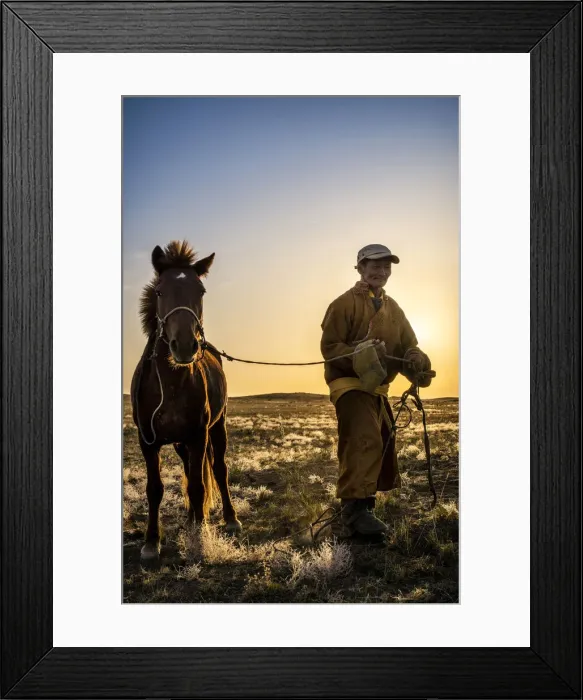 Framed Print : Mongolian shepherd wearing traditional dress in steppe of Gobi desert with his hourse