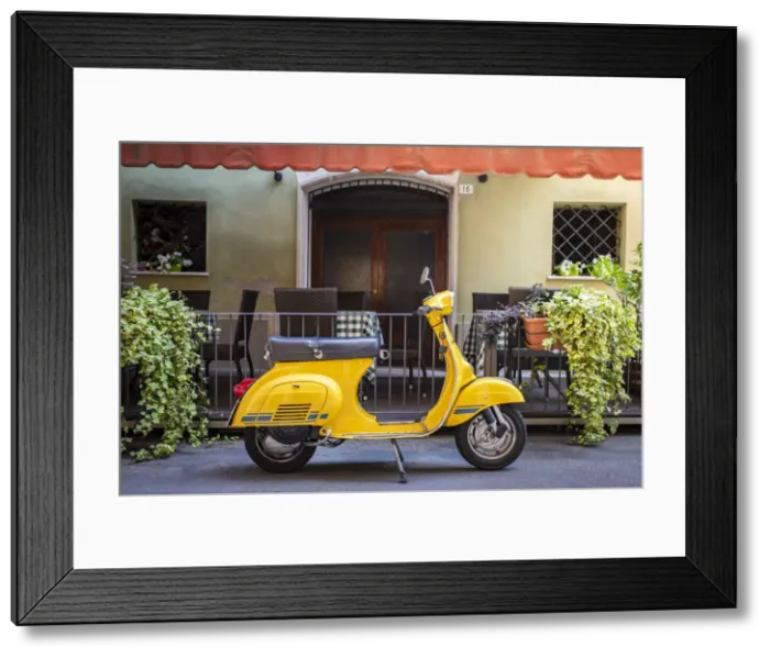 Framed Print : Yellow Vespa in Modena historic city. Modena old town, Emilia Romagna, Italy Framed Print : Yellow Vespa in Modena historic city. Modena old town, Emilia Romagna, Italy