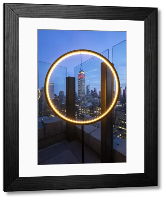Framed Print : The Empire State Buiklding at evening, framed in a rooftop light Framed Print : The Empire State Buiklding at evening, framed in a rooftop light