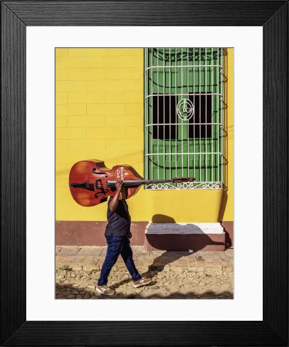 Framed Print : Musician with his double bass walking through the colourful street of Trinidad Framed Print : Musician with his double bass walking through the colourful street of Trinidad