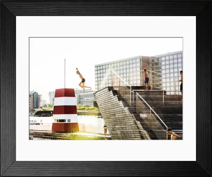 Framed Print : Young people diving into a swimming pool in a water canal in Copenhagen, Denmark Framed Print : Young people diving into a swimming pool in a water canal in Copenhagen, Denmark
