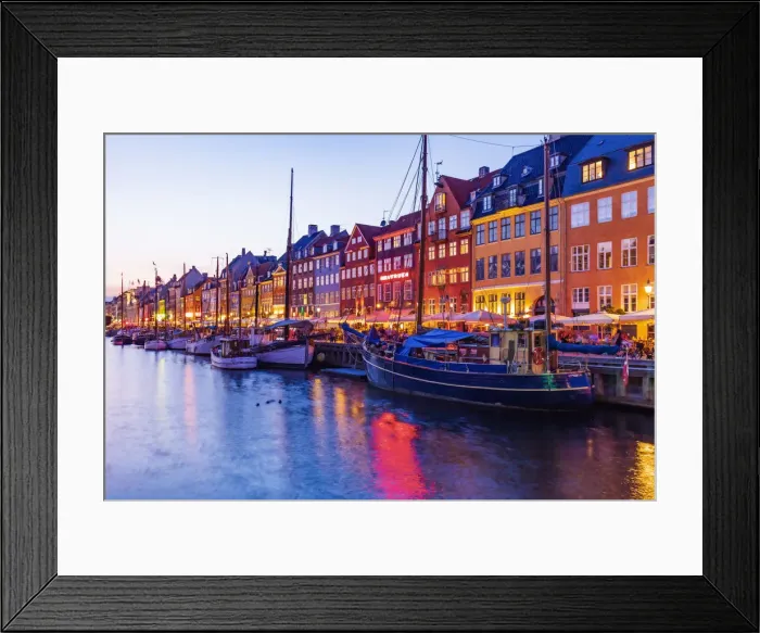 Framed Print : View of colored houses reflecting in Nyhavn water canal by night in Copenhagen, Denmark Framed Print : View of colored houses reflecting in Nyhavn water canal by night in Copenhagen, Denmark