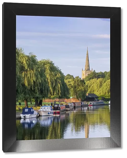 United Kingdom, England, Warwickshire, Stratford, Stratford-upon-Avon, summer view of the river Avon showing the spire of the Church of the Holy Trinity, Shakespearea€™s burial place
